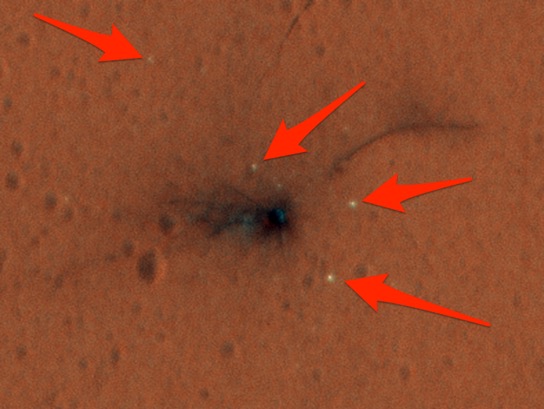 the-black-splotch-is-where-the-european-space-agencys-schiaparelli-mars-lander-crashed-the-white-specks-pointed-out-with-arrows-are-pieces-of-the-lander